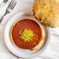 Brown Kunafeh · Sweet cheese topped with finely shredded fillo dough, soaked in hot syrup.