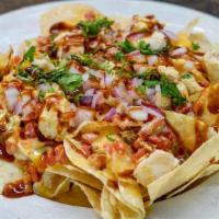 Pluckers Nachos · An old favorite makes its return. Tortilla chips topped with chicken, queso, Honey BBQ sauce...