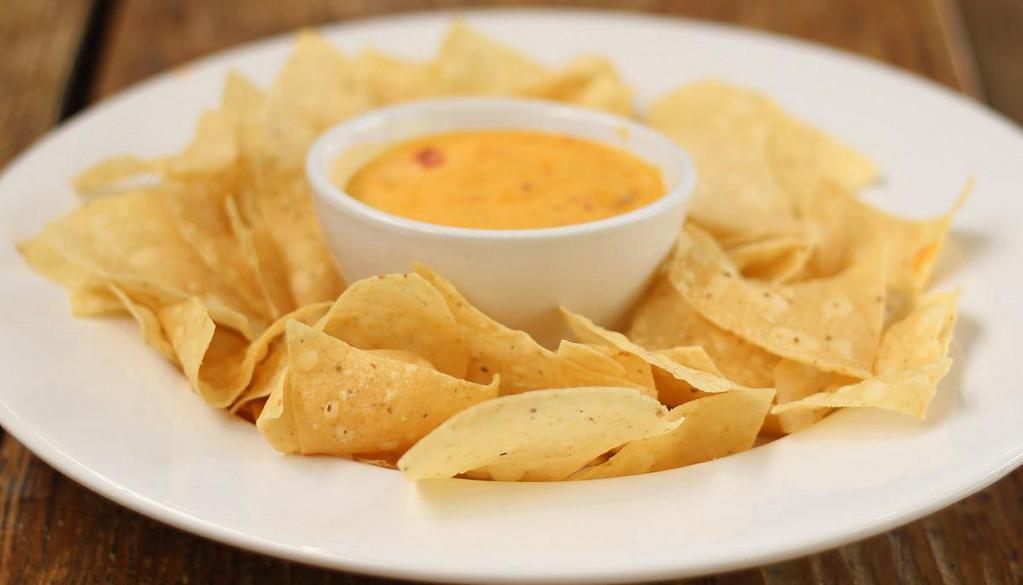 Chips & Queso · We’d be run outta the South if we didn’t have this on the menu.