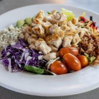 Blue Cheese Chicken Cobb · Grilled chicken, avocado, blue cheese, bacon, tortilla strips, tomatoes, and cabbage all nea...