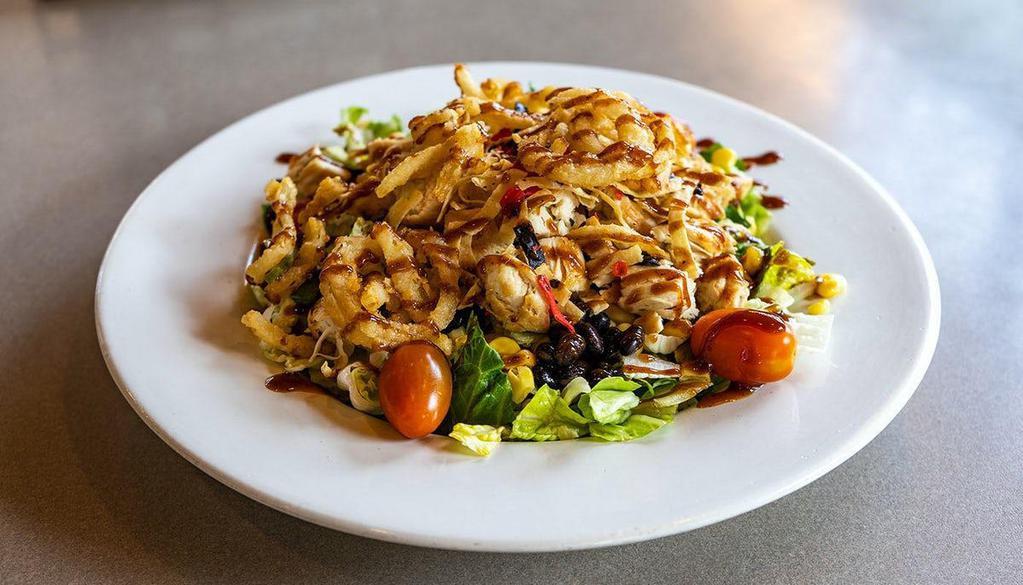Honey Bbq Chicken Chop · A salad full of crunch featuring crisp lettuce, grilled chicken, diced tomato, black beans, corn, our own Honey BBQ sauce, and topped with tortilla strips and onion straws.