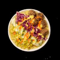 Balls Of Fire · Saffron rice, Spicy Lamb Meatballs, marinated cabbage, dill cucumbers, pepperoncinis, amba a...
