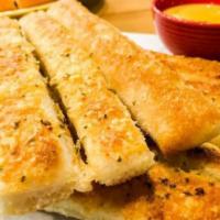 Cheesy Breadsticks · Eight pieces. With marinara sauce.