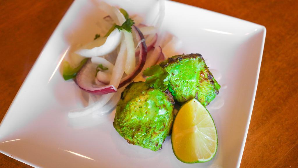 Hariyali Chicken Kabab · Chicken marinated with fresh green herbs served with grilled onion and salad.