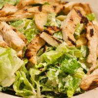 Chicken Caesar Salad · Crisp romaine lettuce tossed in our homemade caesar dressing with grilled chicken strips top...