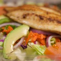 Grilled Tilapia Salad · Grilled tilapia in a bed of crispy greens, mixed with tomatoes, avocado, green onions, red o...