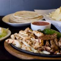 Fajitas Steak, Chicken Or Shrimp · Our fajitas are grilled just right, served over onions on a sizzling platter with rice, refr...