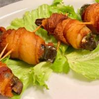 White Wings · Juicy morsels of chicken breast and jalapenos wrapped with smoked bacon.