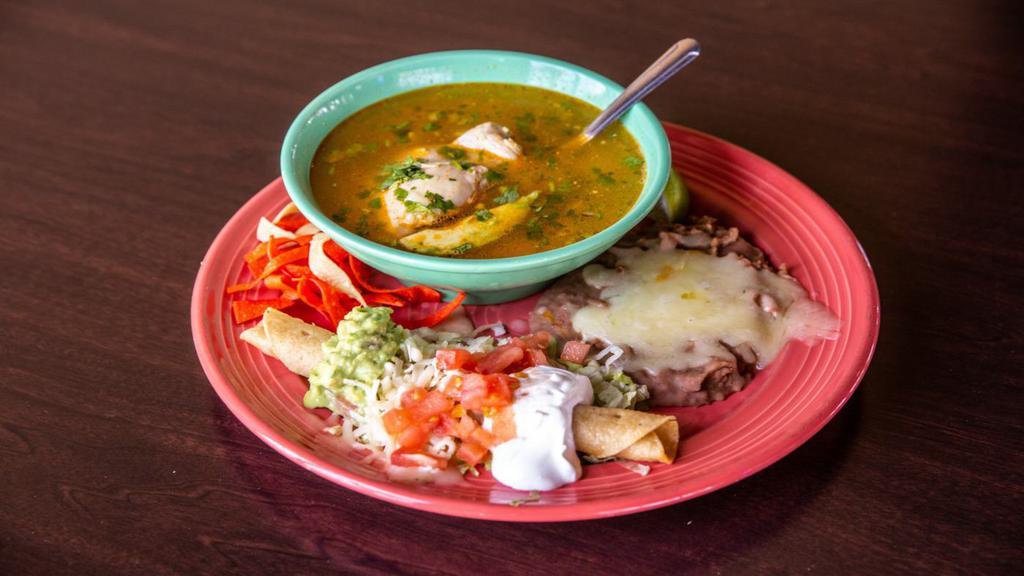 Chicken Soup Combo · A bowl of our award-winning soup, flauta (topped with guacamole, sour cream, Monterrey jack cheese, and tomatoes) and refried beans.