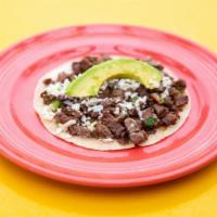 Taco Al Carbon · Certified Angus beef. Diced charbroiled fellas, green onions, cilantro, queso fresco, and sl...