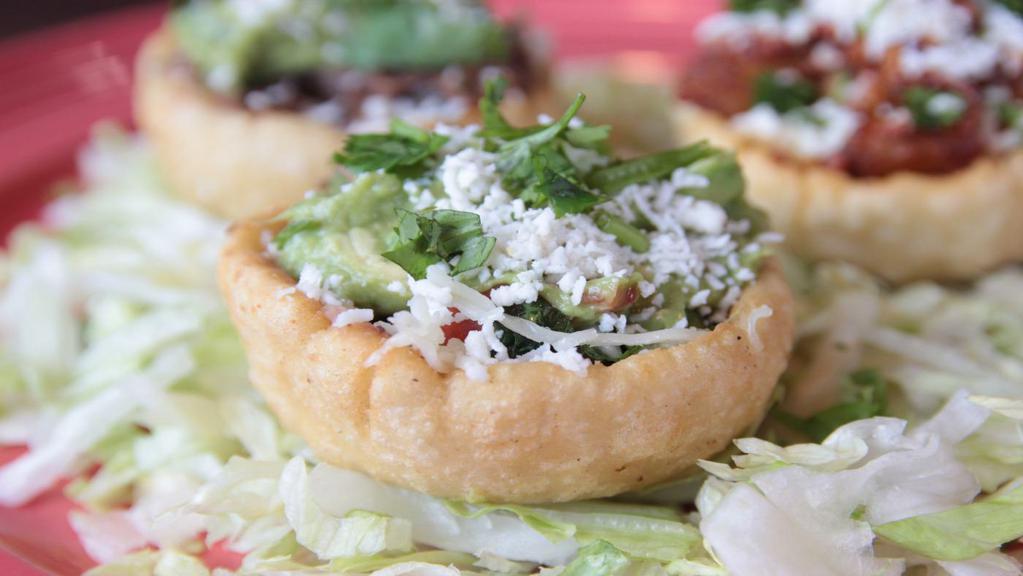 Traditional (Sopes) · Our own homestyle sope with refried beans, Monterey jack cheese, guacamole, cilantro, pico de gallo and queso fresco.