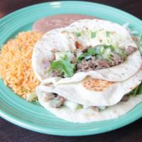 Asada Taco Plate · Two beef asada tacos served with onions or cilantro on the side topped with guacamole sauce....