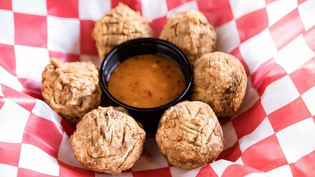 Boudin Balls · Traditional Cajun pork and rice sausage with spicy sauce.