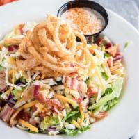 Chopped House Salad · Romaine and iceberg topped with crispy bacon, shredded cheese, diced egg, tomato, cucumbers ...