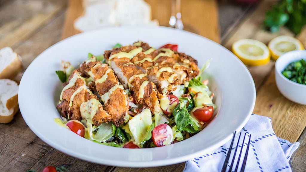 Crispy Chicken Club Salad · Greens tossed with bacon, egg, cheese, cucumber, and tomatoes topped with slices of buttermilk fried chicken breast.