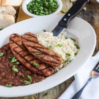 Andouille Sausage Over Red Beans & Rice · A cajun sausage tradition.