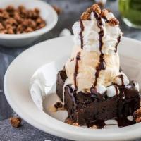 Crescent City Mud Sundae · Giant warm brownie topped with melted marshmallow, nuts, vanilla ice cream and chocolate sau...