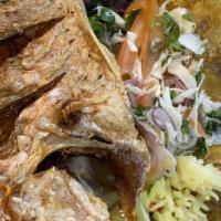 Pescado Frito · Fried Red Snapper served with white rice, side salad, and tostones