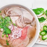 Pho Tai Nam · Rice noodles with slices of rare beef tenderloin and brisket in a beef broth.