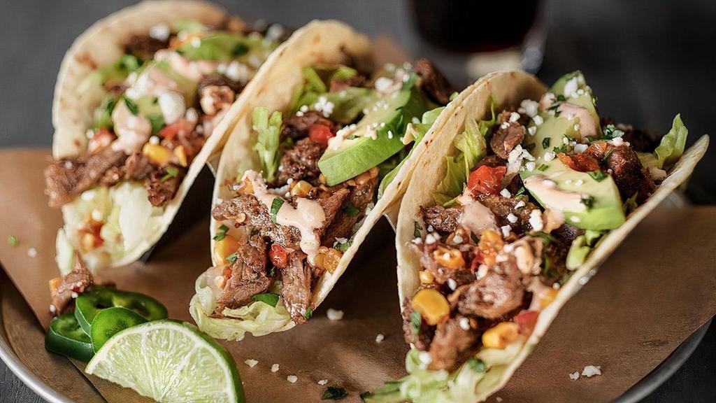 1 Beef Barbacoa + Sriracha Lime Aioli · Topped with freshly-made roasted tomato & corn salsa, shredded lettuce, avocado, fresh cilantro & queso fresco, served in a lightly grilled tortilla.