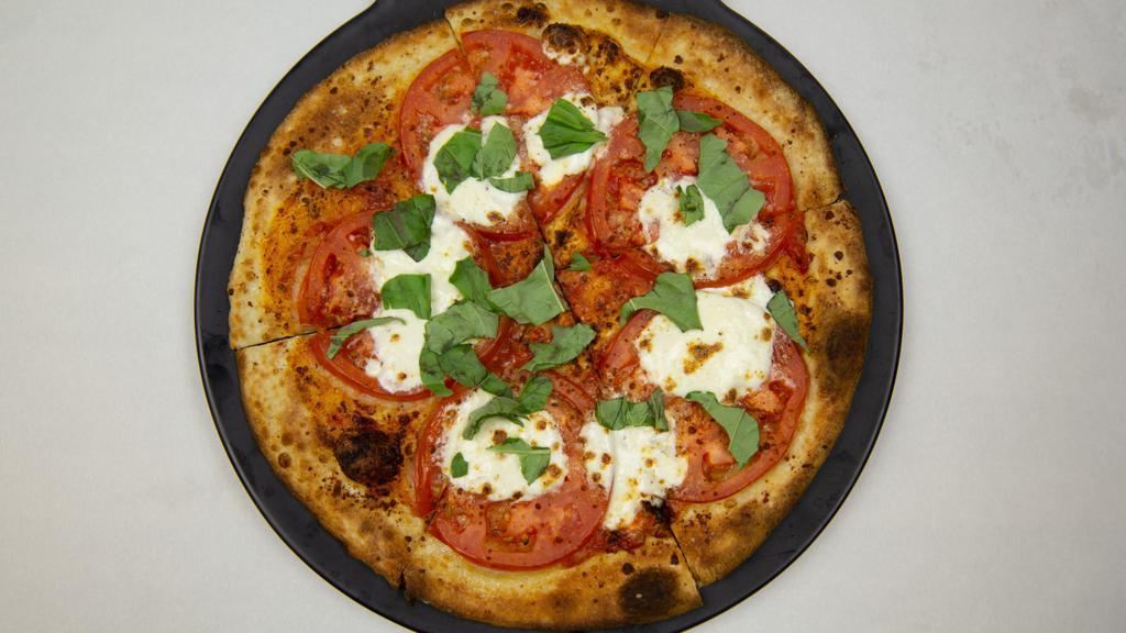 Margherita Pizza · One of our favorites. Marinara, fresh mozzarella, Parmesan and Romano, roma tomatoes, and fresh torn basil.