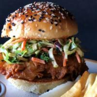 Fried Chicken Sandwich · A burst of savory and spicy flavor in every bite, with sriracha soy, Brussel sprout slaw, ca...