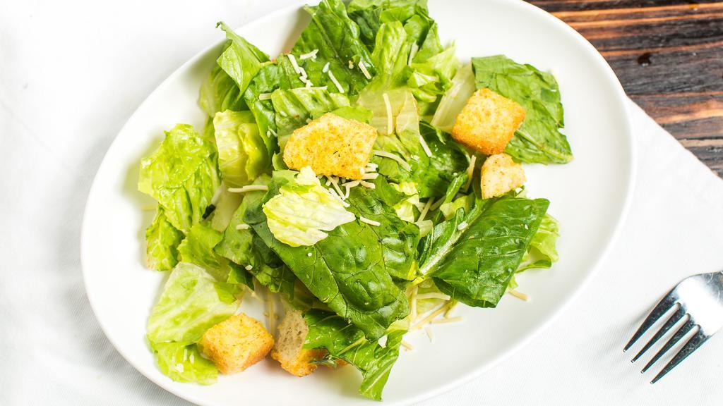 Caesar Salad · Fresh romaine tossed with our Caesar dressing topped with croutons and parmesan cheese.
