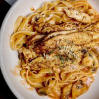 Blackened Chicken Pasta · Fettuccine alfredo and mushrooms topped with sliced blackened chicken breast.