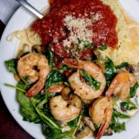 Shrimp Pasta · Shrimp sautéed with spinach, mushrooms, and pine nuts in lemon butter. Served with a side of...