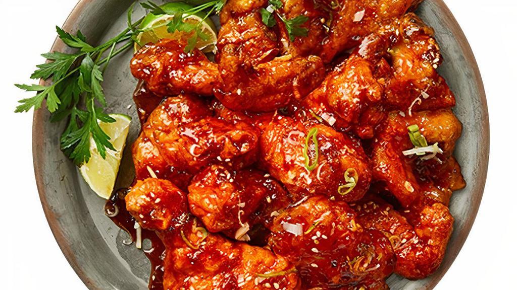 Spicy Galbi Wings · Sweet and savory, yet a deliciously spicy sauced off the grill flavor. Mixed with green onions and garnished with sesame seeds.