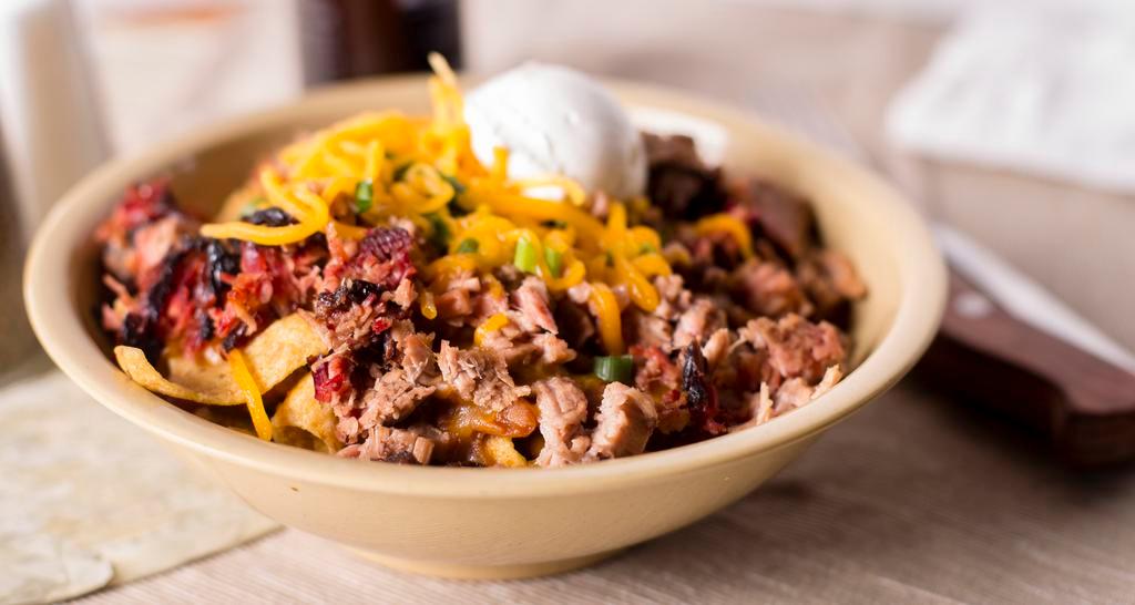 Frito Pie · Our original recipe – Fritos corn chips topped with chopped brisket, BBQ beans, cheese, chives, sour cream, and Sonny Bryan’s BBQ Sauce.