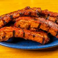 Pork Ribs · Smoked pork ribs, finished on the grill with Sonny Bryan’s BBQ sauce.