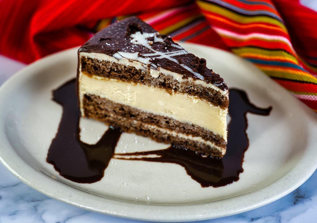 Chocolate Tres Leches Cheesecake · Cheesecake, chocolate and tres leches all together is one great taste! Topped with a drizzle of chocolate and dusted with powdered sugar.