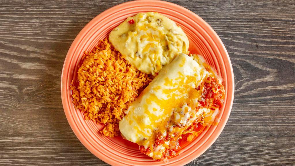 Fajita Enchiladas · Two flour tortillas filled with your choice of fajita beef or chicken, topped with Chile con queso. Served with guacamole.