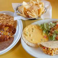 Monterey Dinner · Two cheese enchiladas with gravy, a bean chalupa, beef taco, tamale with chili, Chile con qu...