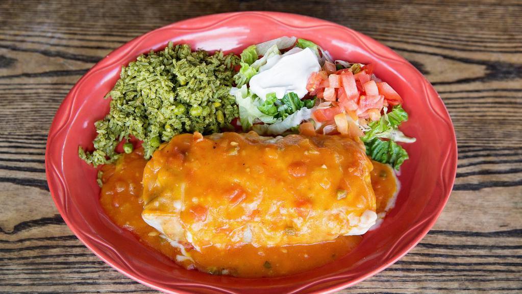 Fajita Burrito · Flour tortilla stuffed with char-broiled chicken with grilled onions and bell peppers, covered with Chile con queso. Served with guacamole, rice, and refried beans.