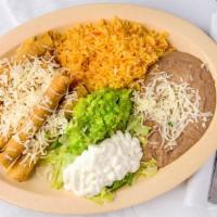 Flautas · Three crispy rolled corn tortillas filled with chicken or shredded beef and potato. Topped w...