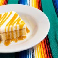 New Tres Leches  · A moist three milk cake with dairy whipped cream icing and drizzled with bourbon flavored ca...