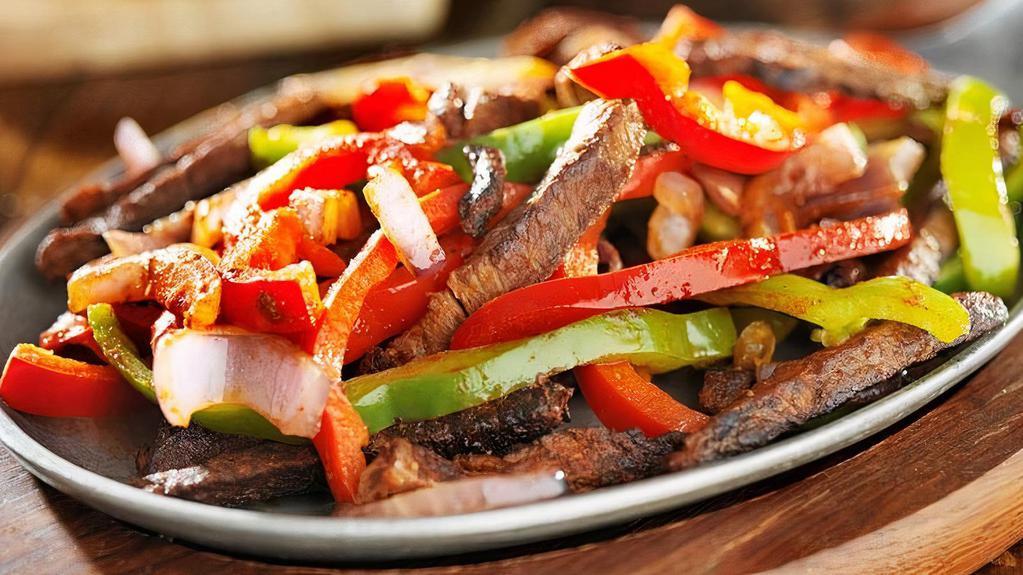 Traditional Fajitas · Your choice of beef or chicken fajitas grilled to perfection, served with homemade guacamole fresh pico de gallo, sour cream, grated cheese refried beans, Mexican rice and flour tortillas.