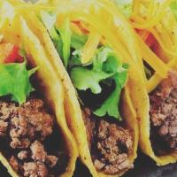Original Taco Dinner · Three crisp tortilla shells filled with seasoned beef or hand pulled chicken and garnished w...