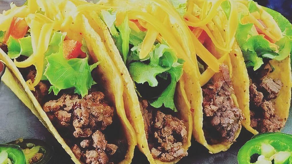 Original Taco Dinner · Three crisp tortilla shells filled with seasoned beef or hand pulled chicken and garnished with fresh lettuce, tomatoes, and grated cheese. Served with Mexican rice and refried beans.