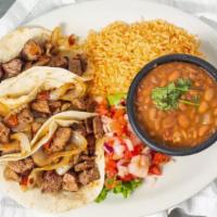 Tacos Al Carbon · Three flour tortillas filled with marinated, USDA Choice Angus sirloin steak, grilled onions...