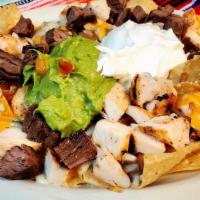 Nachos - Fajita · Homemade chips topped with refried beans, melted cheese and your choice of beef or chicken f...