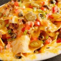 Nachos - Deluxe · Homemade chips topped with refried beans, melted cheese, seasoned ground beef, hand pulled c...