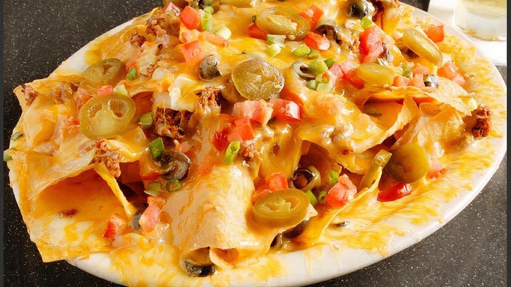Nachos - Cheese · Homemade chips topped with melted cheese,  Garnished with pico de gallo.