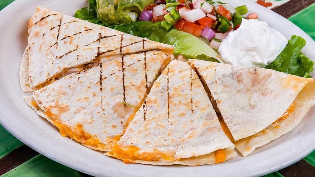 Fajita Quesadilla · A large grilled flour tortilla stuffed with your choice of beef (+$1.00) or chicken fajitas, cheddar and Jack cheese, grilled bell peppers & caramelized onions. Served with guacamole, sour cream and fresh pico de gallo.