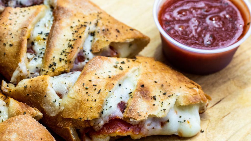 Pepperoni Stromboli · Eight pieces of stromboli packed with cheese and pepperoni, sprinkled with Italian seasoning and served with two sides of our homemade pizza sauce