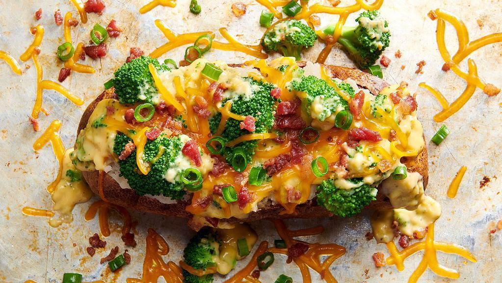 The Buckin' Broc'N Cheese    · A big ol’ spud topped with heaps of broccoli, a ladleful of broccoli cheese soup, a load of cheddar cheese, crumbled bacon, green onions and our best wishes for you to finish it.