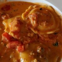 Lobster Ravioli · 4 jumbo raviolis sauteed with tomatoes, garlic, basil, and served in our sherry wine pink cr...