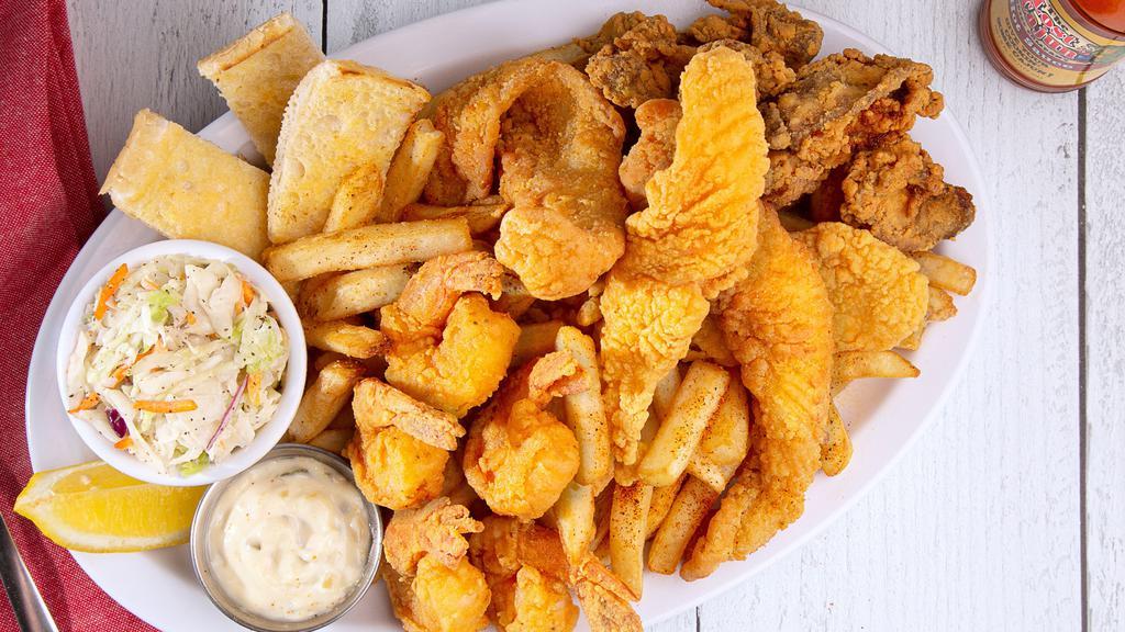 Fried Seafood Platter · Four large tail-on shrimp, four strips of fried catfish and four crispy oysters, served with hushpuppies.